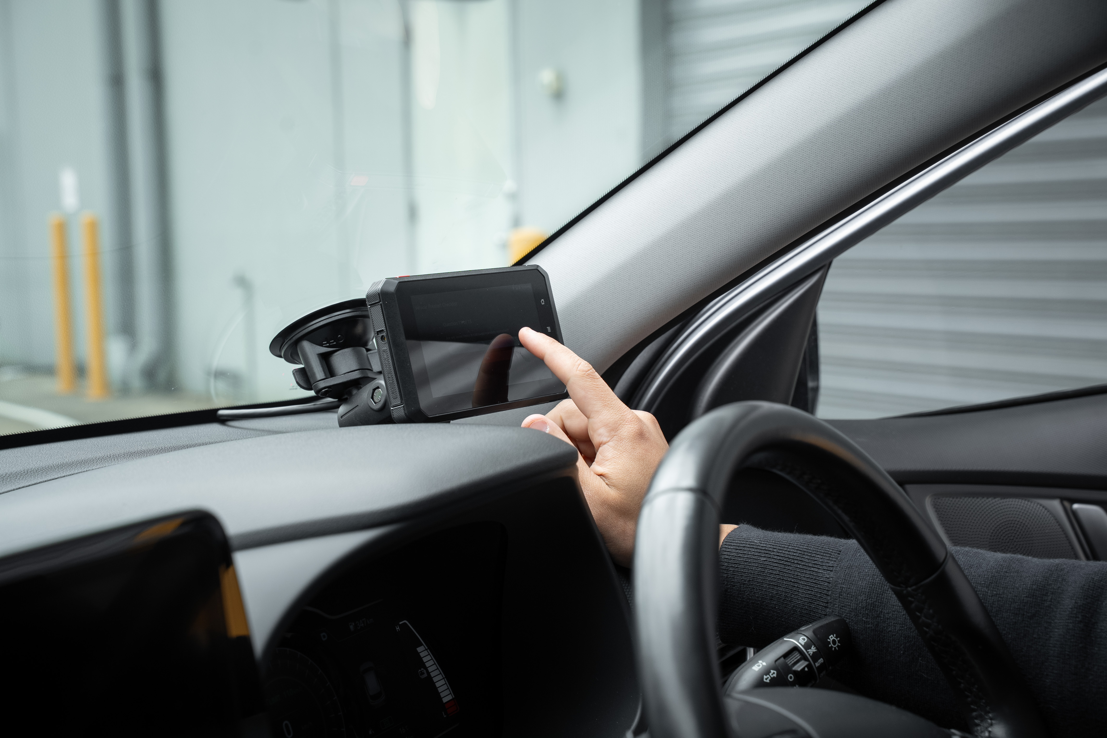 In-cabin tablet mounted in a vehicle for driver workflows and transport forms.